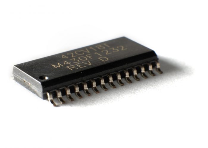 Close up SMD electronic chip in SOIC case. The concept of electrical appliances and equipment